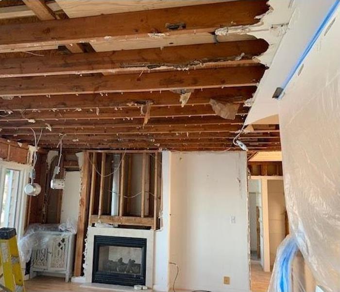 Living room, fireplace and hallway with demolished walls and ceiling
