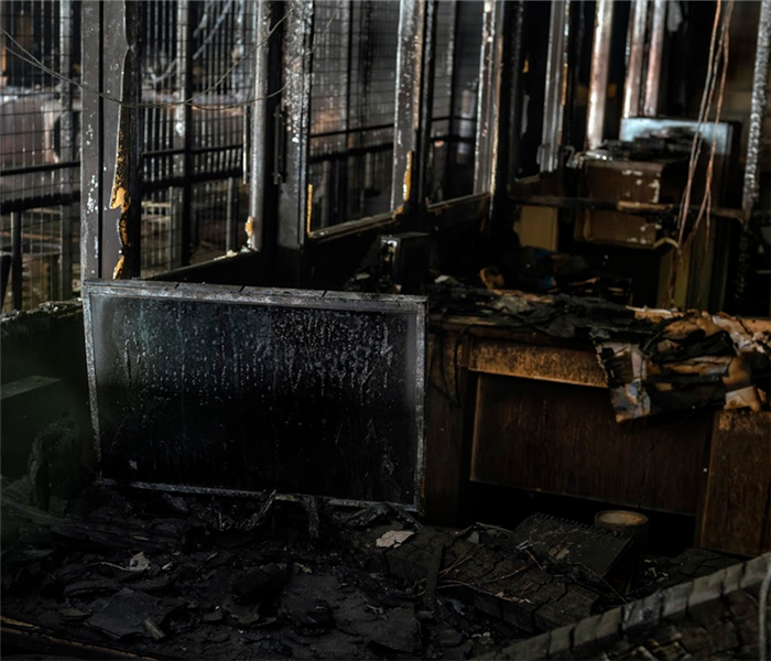 a fire damaged office with soot covering the computers and desks